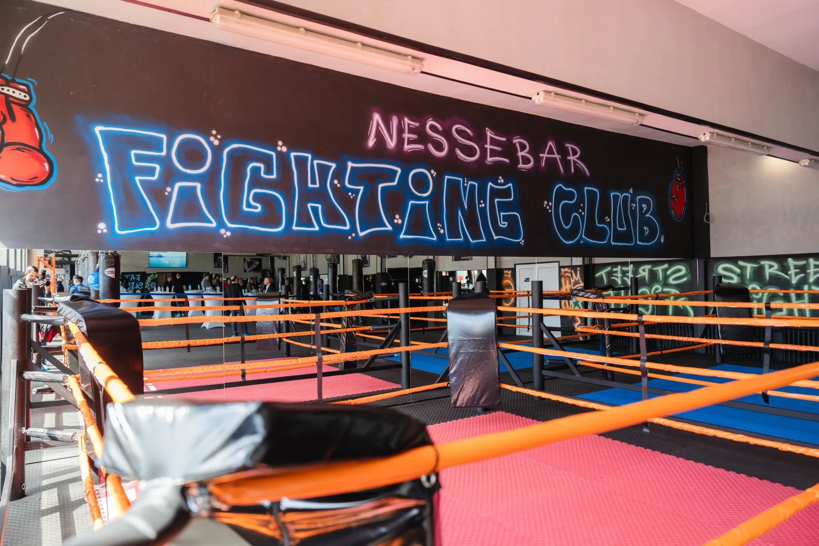 Зала на Nessebar Fighting Club в Несебър — ринг с татами в червено и синьо, чували и графити с логото на клуба