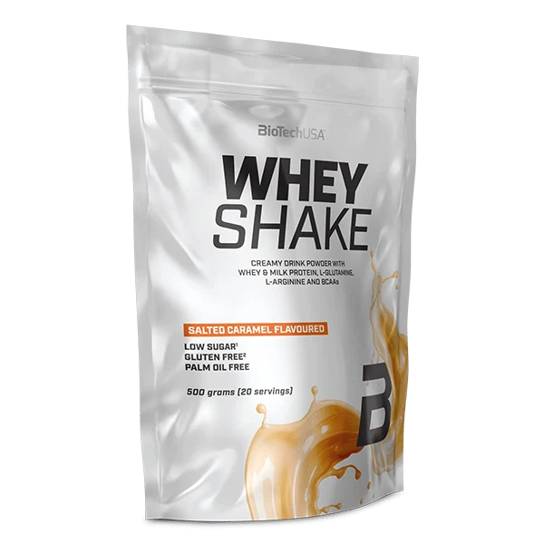 Опаковка на BioTech USA Whey Shake 500 g с вкус на солен карамел, на фона на карамелени бонбони.