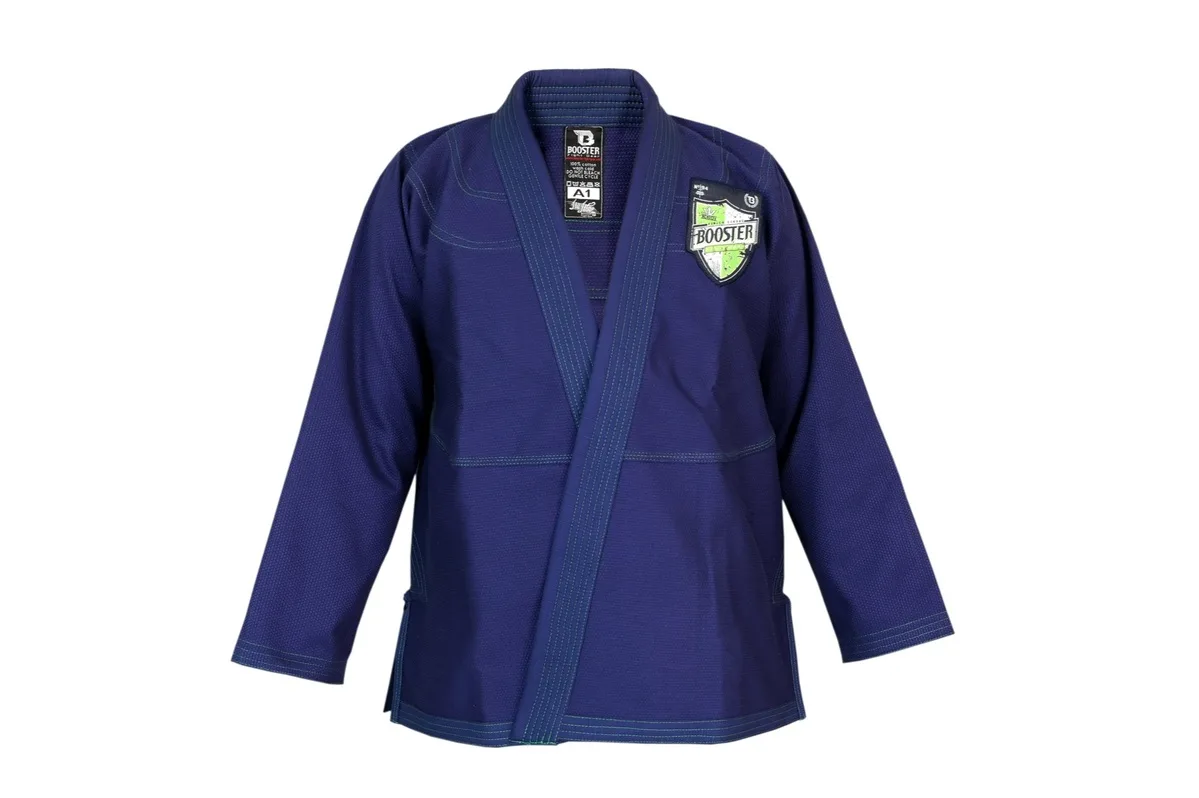 Детайлен изглед на горнището на Booster BJJ V 2 PRO SHIELD BLUE, показващ логото на гърдите и контрастните шевове.
