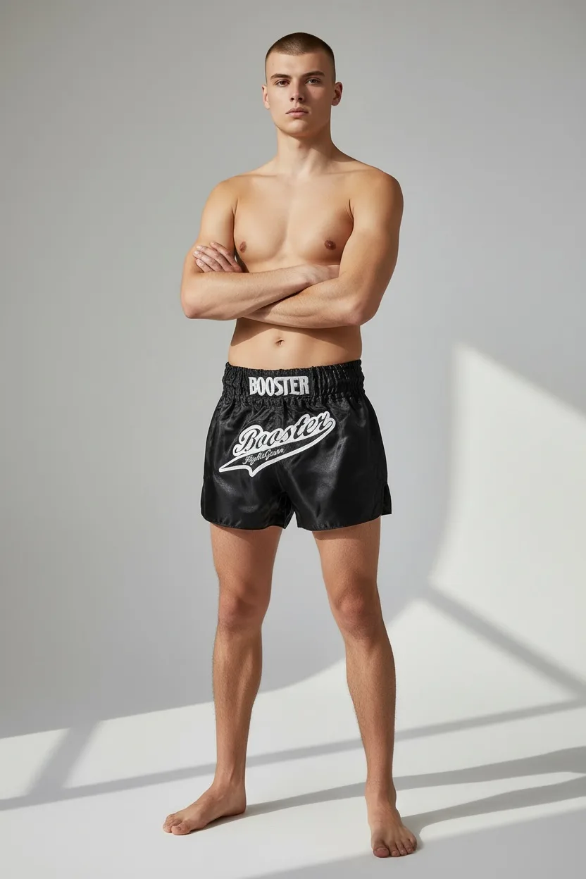 Групова снимка на муай тай шорти Booster TBT SLUGGER BLACK, подредени в различни размери.