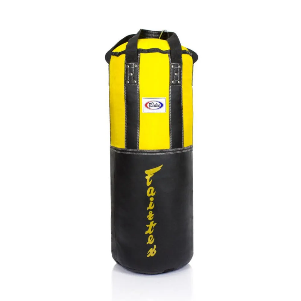 Fairtex Extra Large Heavy Bag HB3 в черно и жълто, окачен и готов за тренировка, показващ издръжливата си конструкция и отличителен дизайн.