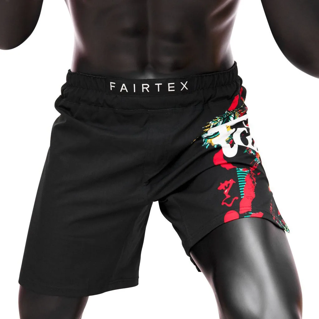 Черни ММА шорти Fairtex "Wild" с бяло лого и графика на левия крак, показани отпред на бял фон.