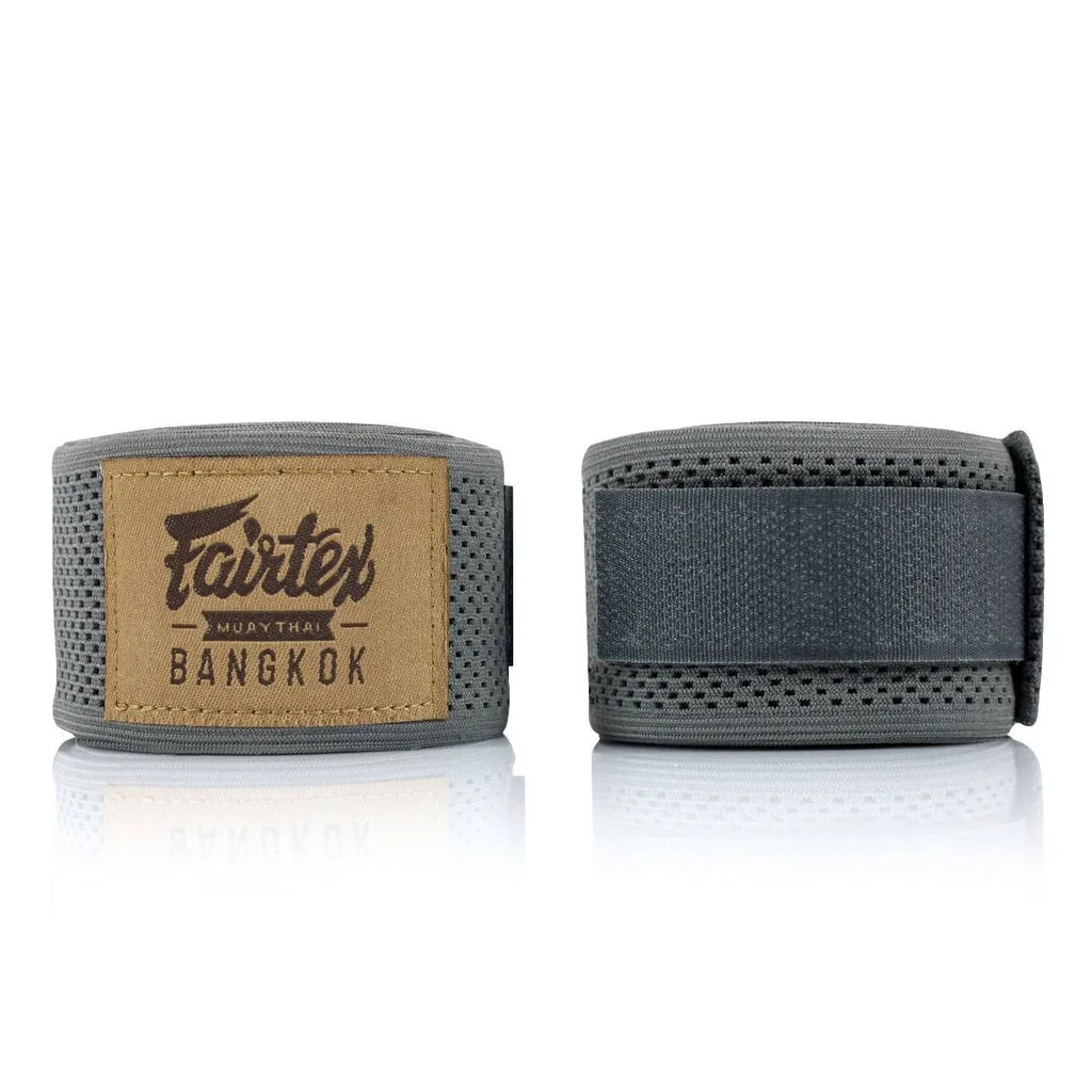 Fairtex Professional Elastic Hand Wrap HW4 в сив цвят, навити на руло, показващи логото на Fairtex и еластичната материя.